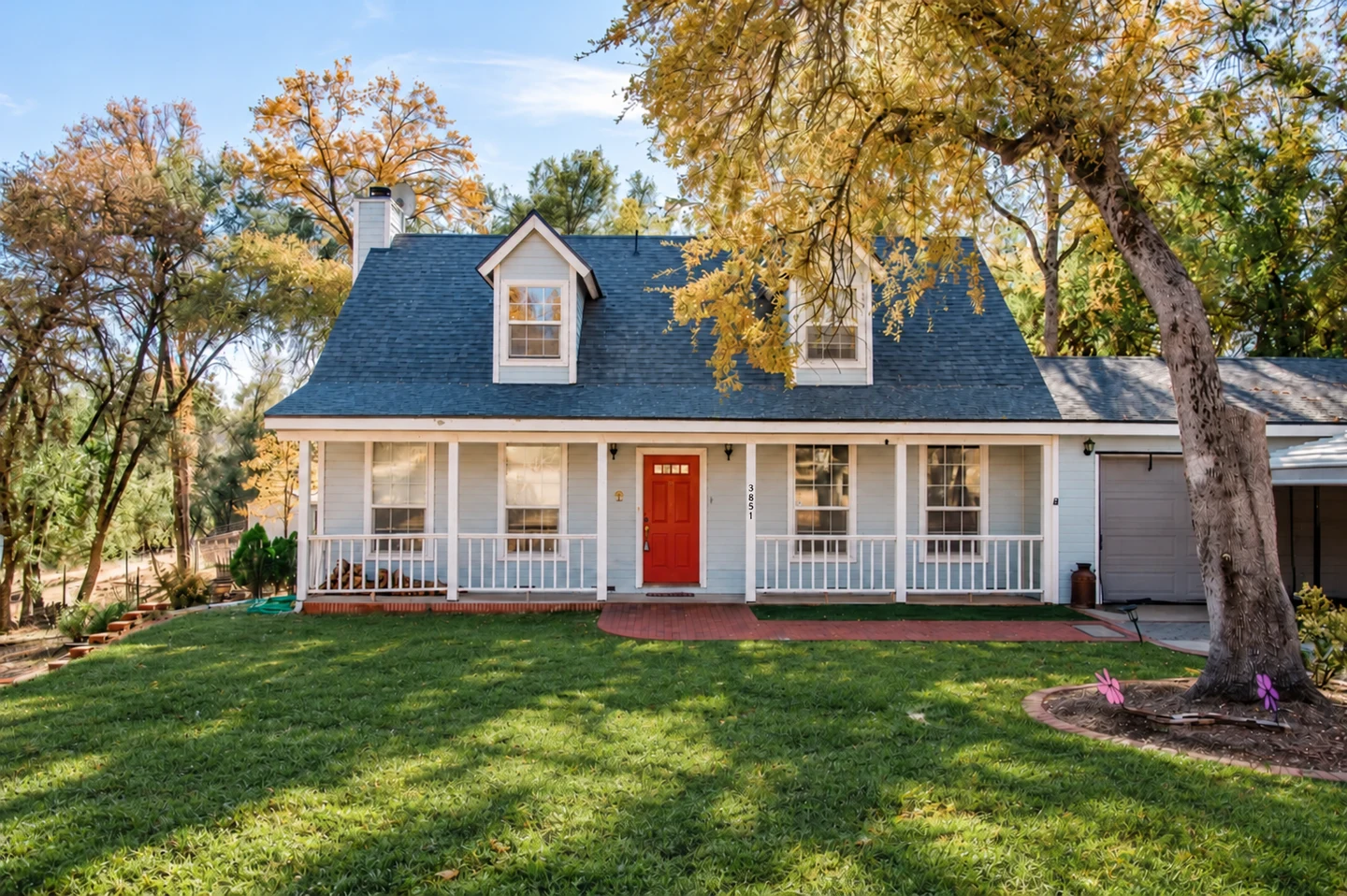 TRADE house at 3851 with a green lawn and shaded front porch.