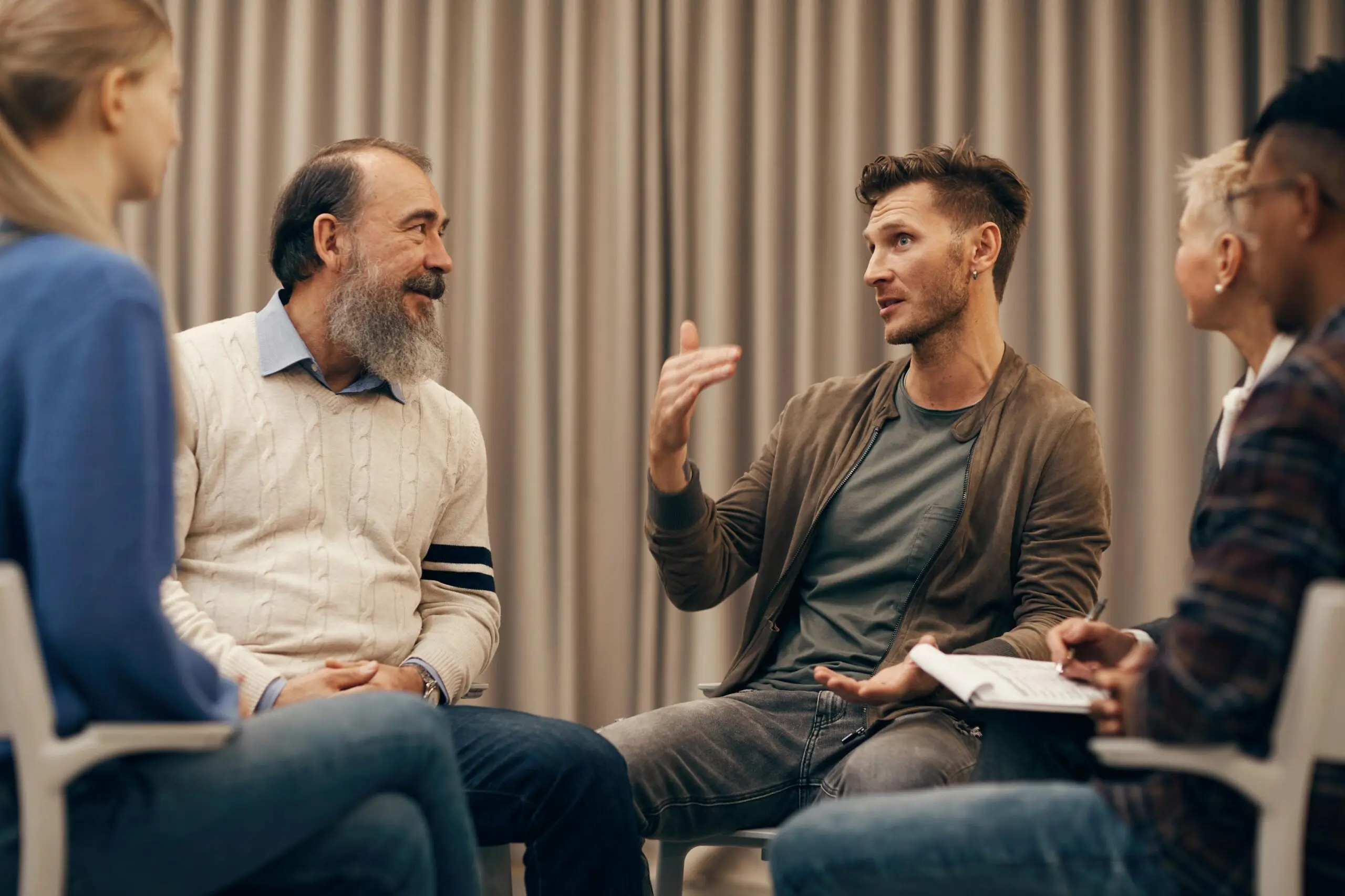 Two men discussing ideas in a casual meeting setting.