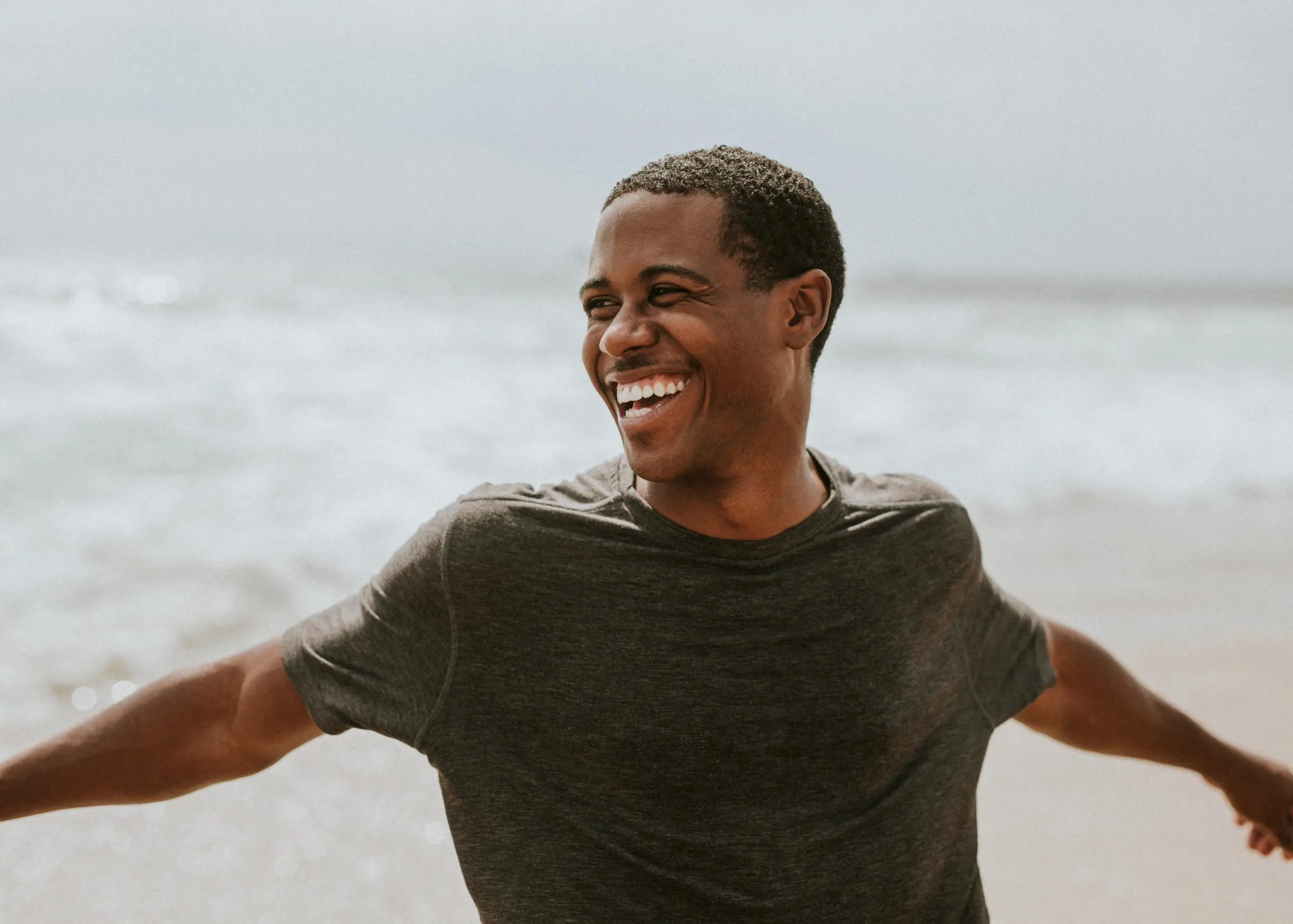Smiling man enjoying a breezy day at the beach.